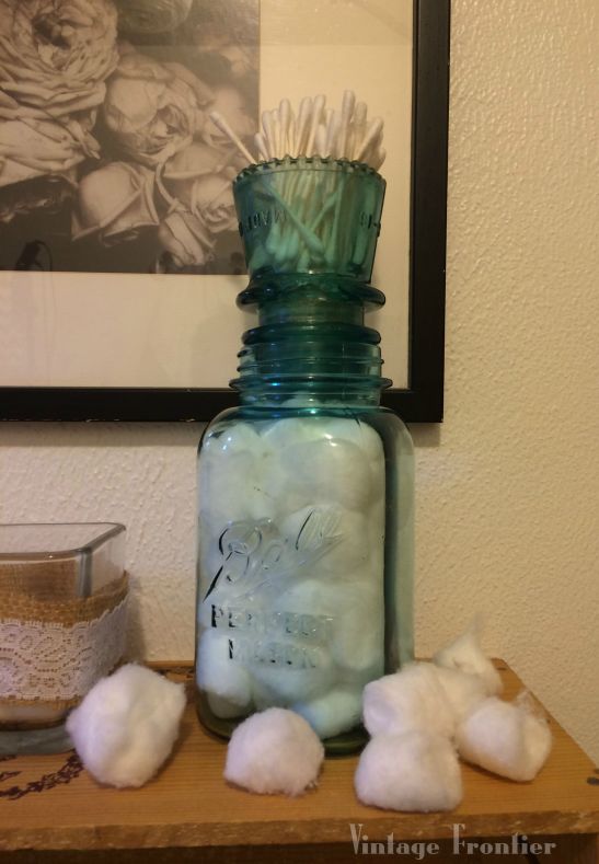 What do you get when you combine an antique mason jar and an insulator? Great Bathroom storage.